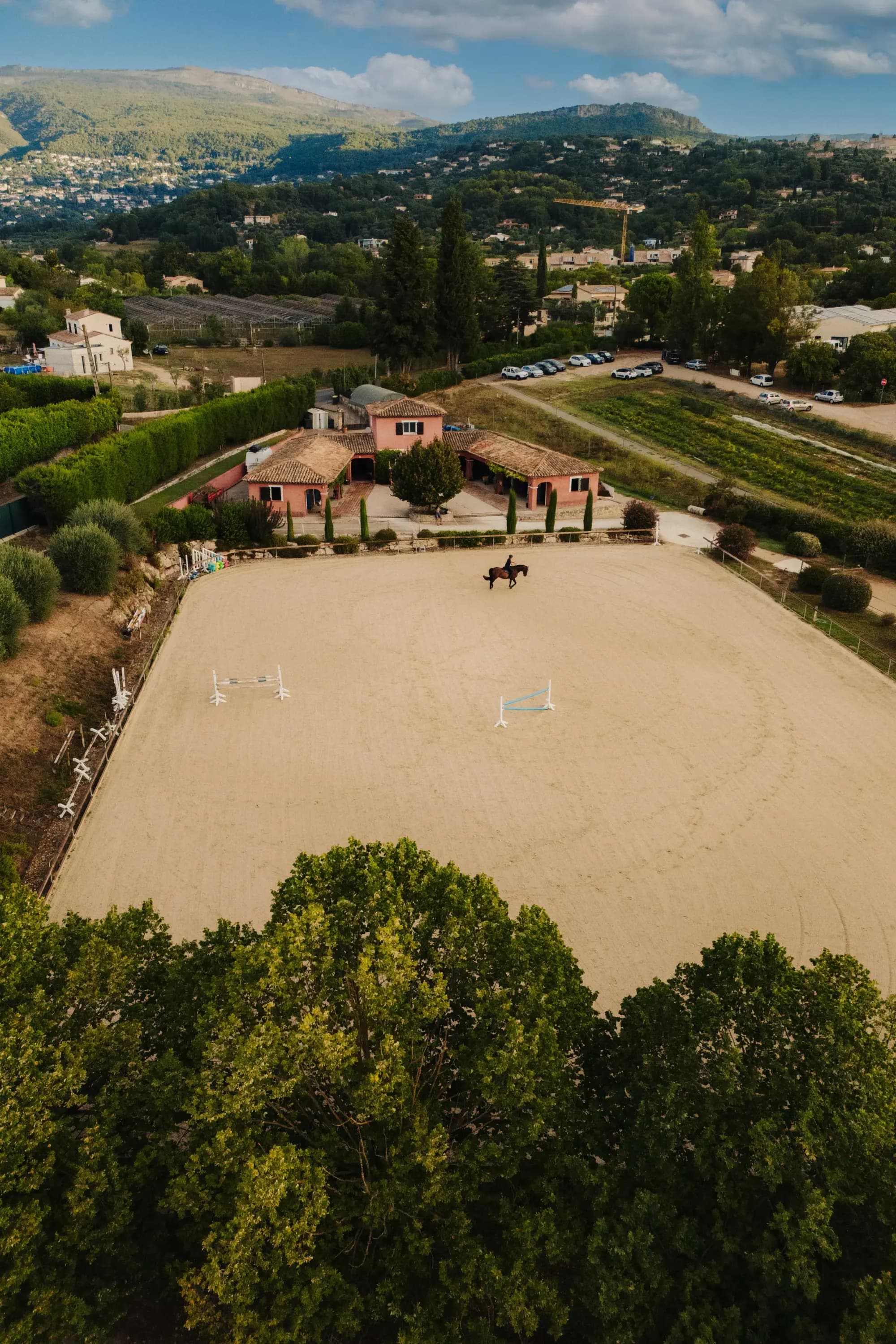 Aerial view of the arena with jumps and the stable buildings