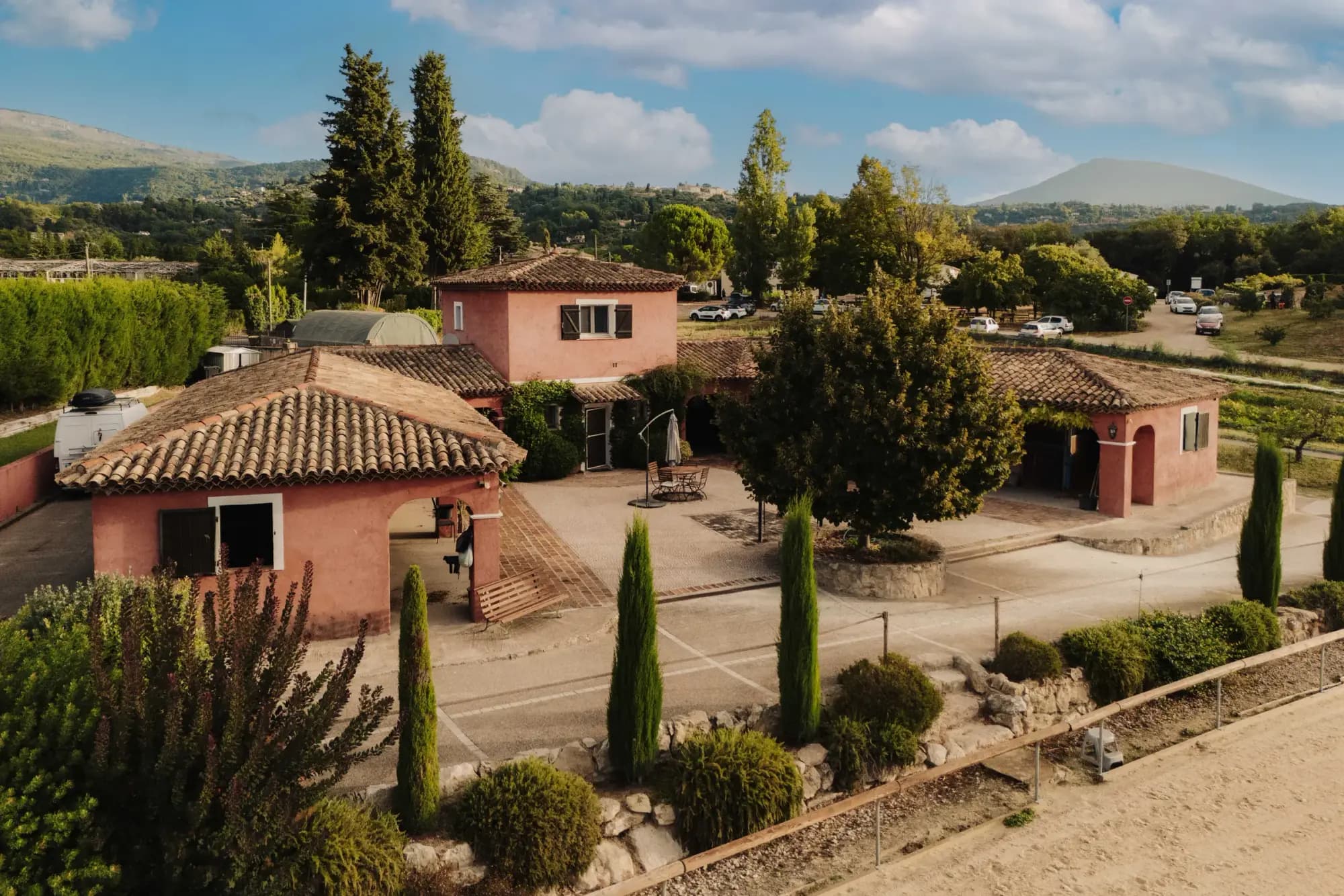 Aerial view of the Écurie des Fées stables and arena among the green hills above Grasse