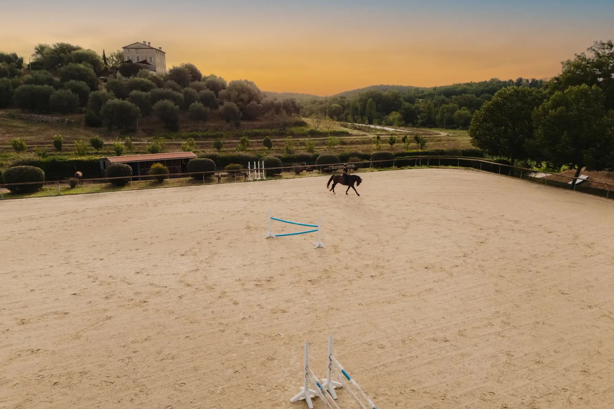 The arena at sunset with the hills of the Côte d'Azur behind