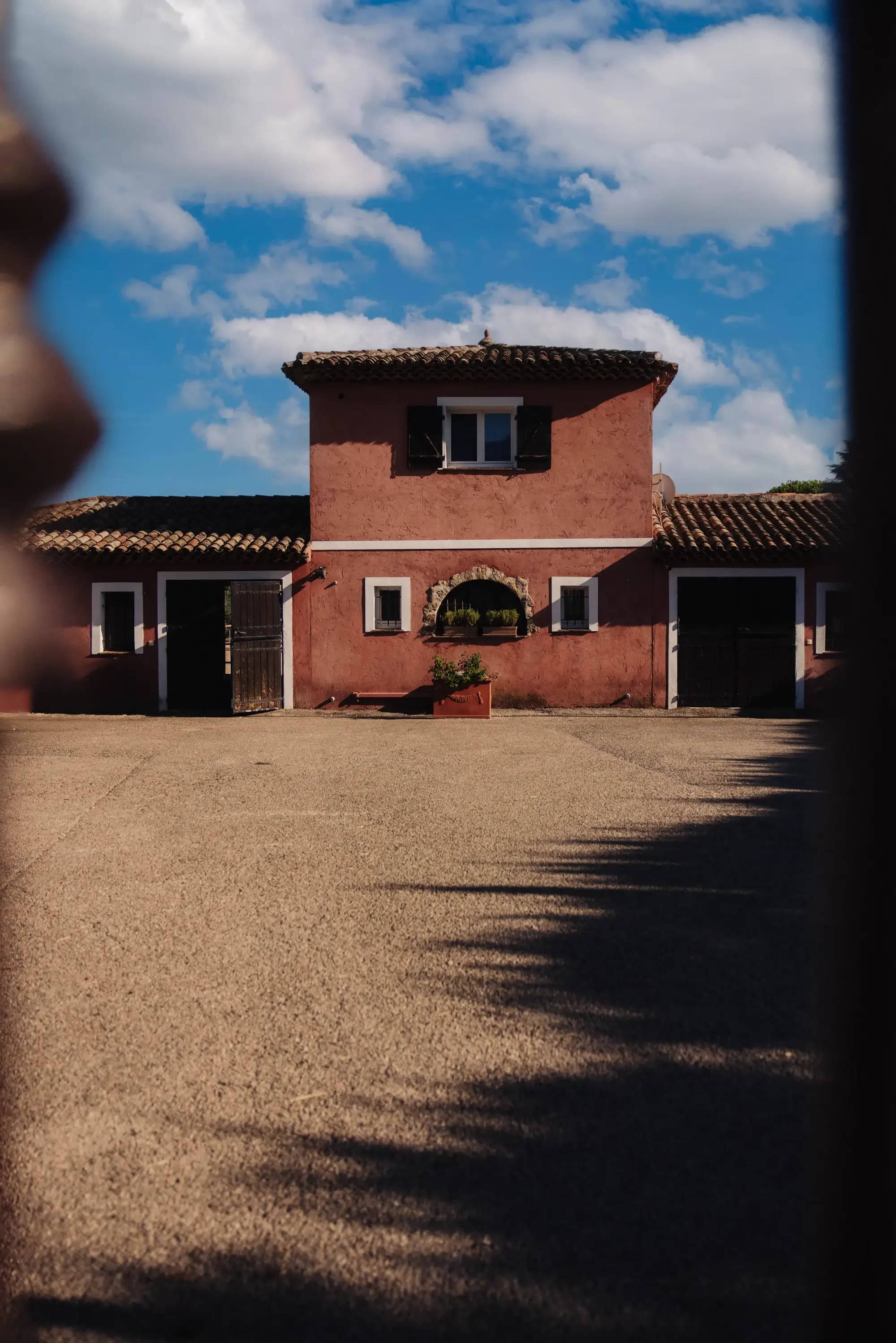 The stable courtyard in front of the terracotta buildings
